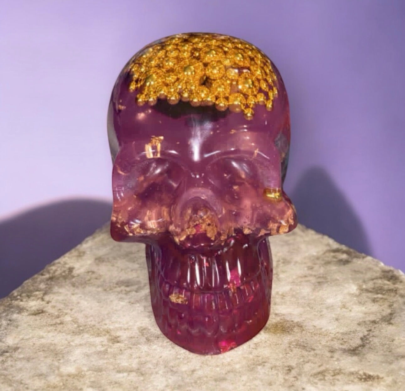 Gold and pink glow in the dark resin skull home decor